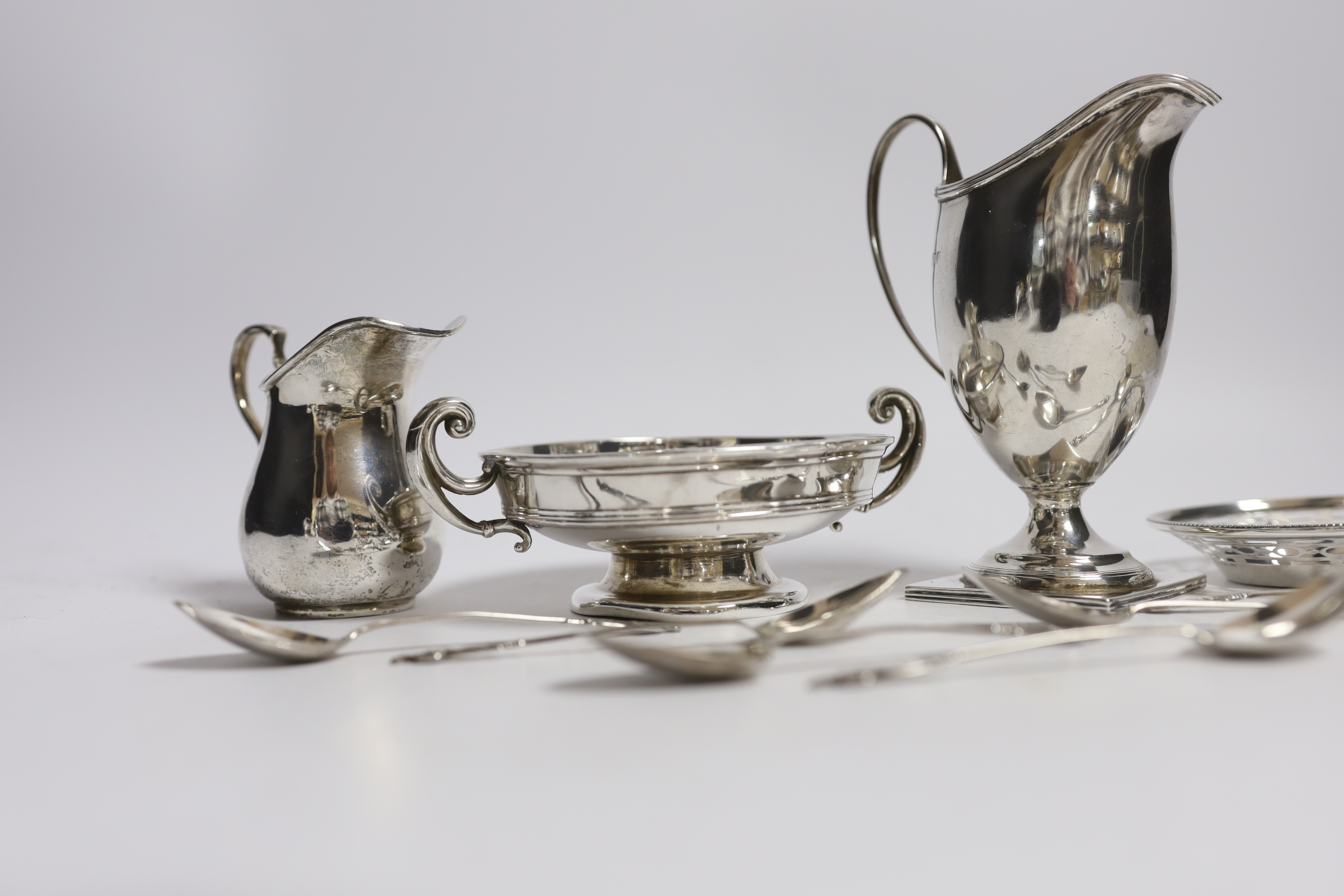 Two George V silver cream jugs, largest 12.5cm, a silver two handled pedestal bowl, a pierced small dish and set of six small silver coffee spoons.